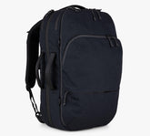 Black Pakt. backpack with padded shoulder straps, front zip pocket, and patterned rope zipper pulls.