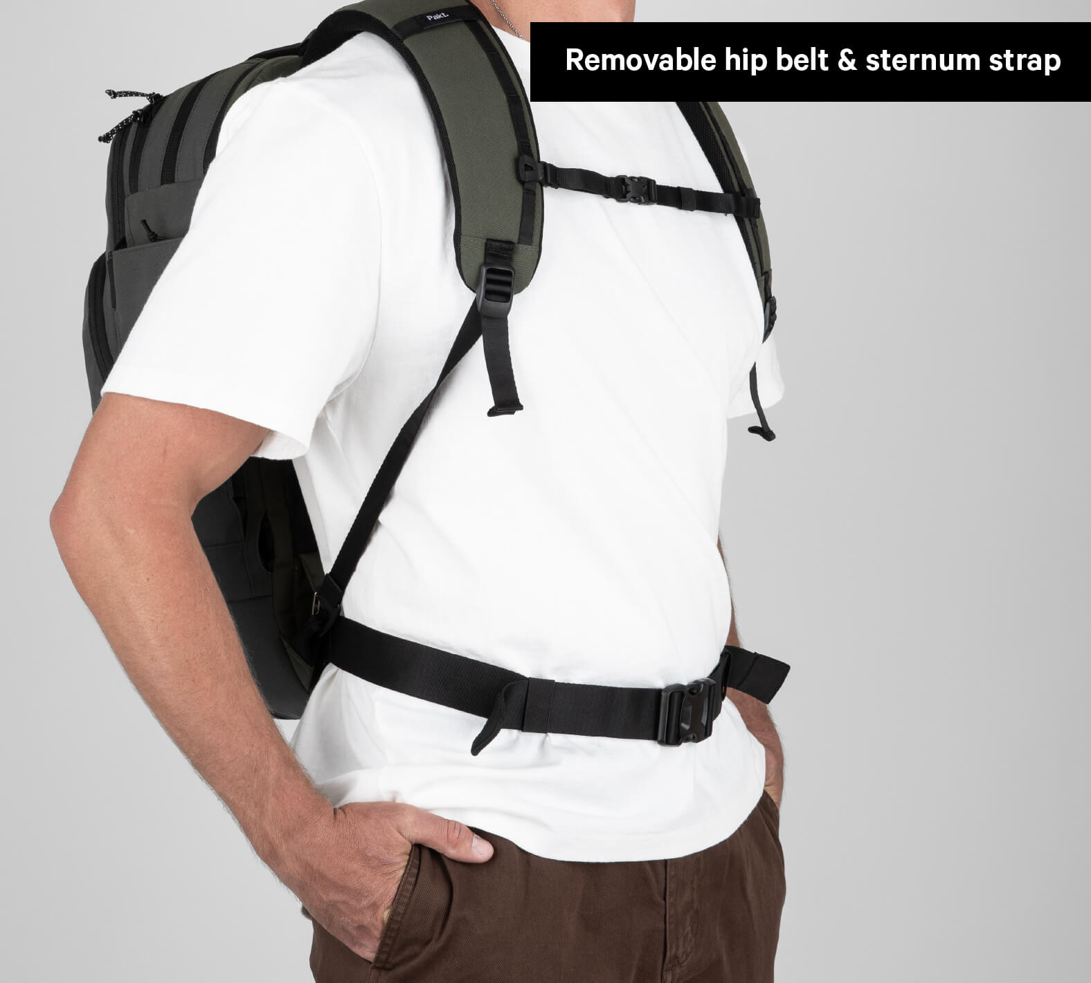 Person wearing a travel backpack with removable hip belt and sternum strap