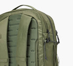 Olive-green backpack back panel with molded foam padding, padded shoulder straps, and a side zipper pocket.