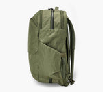 Olive-green backpack in profile with exterior pocket and padded shoulder straps.