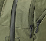 Close-up of the Cypress Aero Travel Backpack showing the fabric with two black zipper pulls on a travel bag or backpack.