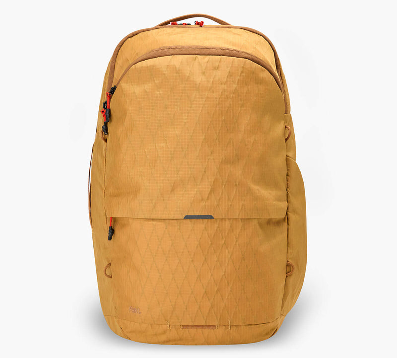 Mustard-yellow structured backpack with front zip pocket, diamond-quilted pattern, and top carry handle.