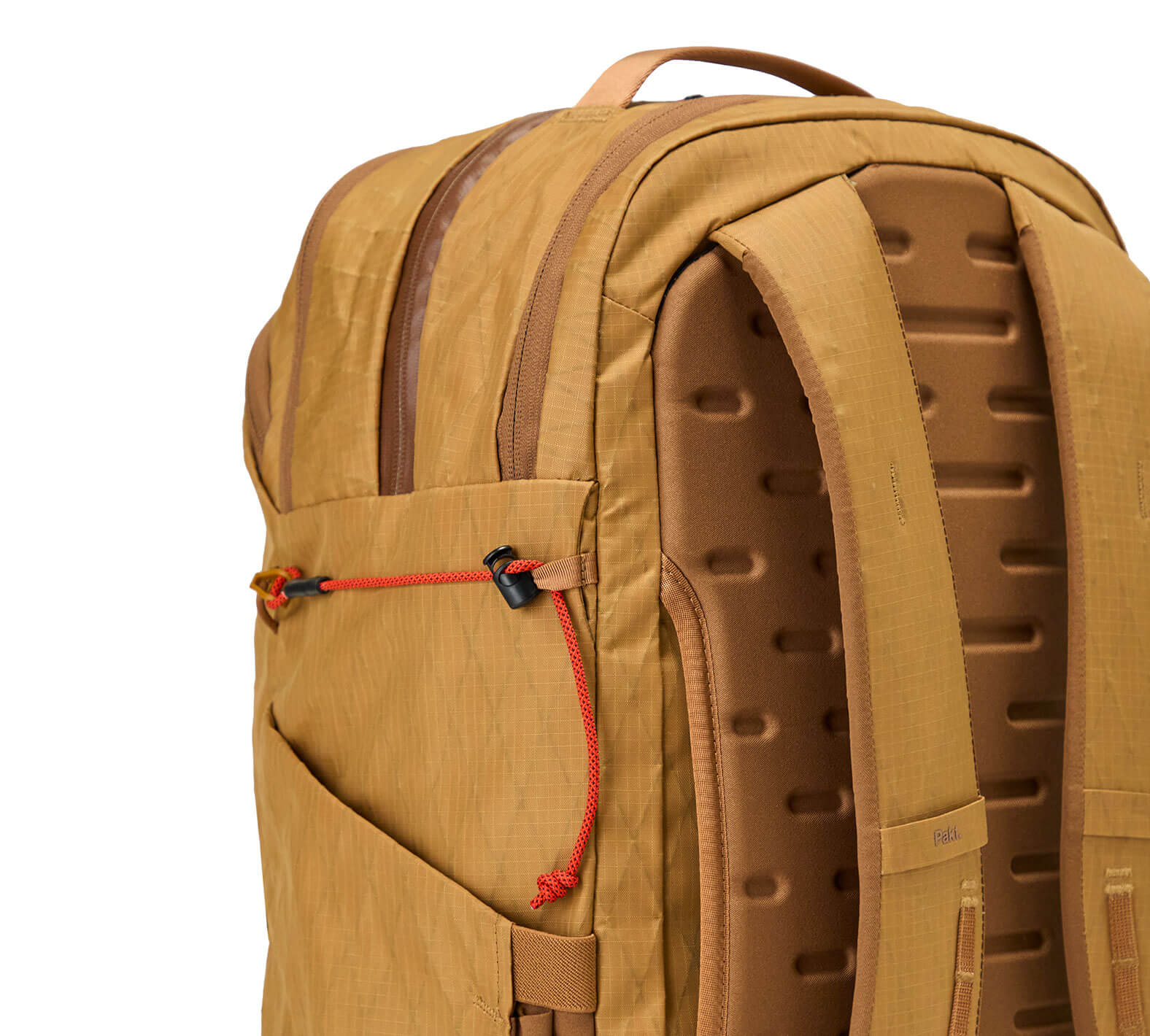 Tan Mojave backpack back panel with padded shoulder straps, ventilation channels and red elastic bungee cord detail