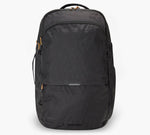 Black commuter backpack with front zip pockets, top handle, side water-bottle pocket, and subtle diagonal texture.