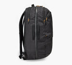 Black vertical travel backpack with two front zip compartments, side pocket and padded shoulder straps