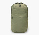 Olive green backpack with top carry handle, dual zipper closure, and front zip pocket.