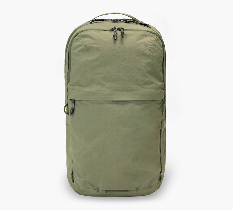 Olive green backpack with top carry handle, dual zipper closure, and front zip pocket.