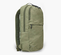 Three-quarter front view of Stash Packable Backpack 16L showcasing cypress recycled nylon and front zip pocket on white background