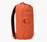 Orange backpack, side view; padded shoulder strap, vertical zip pocket, and top carry handle.
