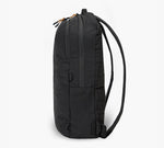 Side view of black packable backpack with two zippered compartments and slim shoulder straps.