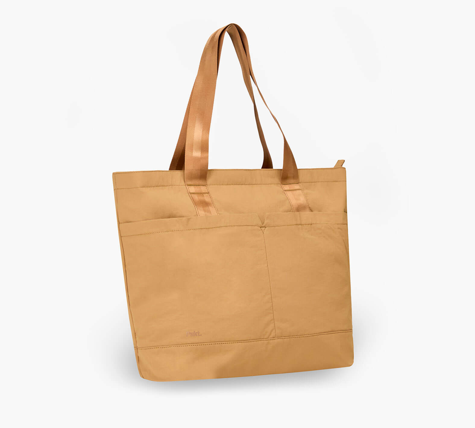 Front view of Stash Packable Tote 20L in Mojave showcasing front zip pockets and long shoulder straps on white background