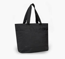 Black canvas tote bag with two shoulder straps, front exterior pocket and reinforced base