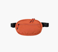 Front view of Stash Packable Sling 4L in Sumac showcasing front zip pocket and black adjustable strap on white background
