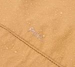 Close-up of the Mojave aeroweave fabric with water droplets and the word 'Pakt' embroidered.