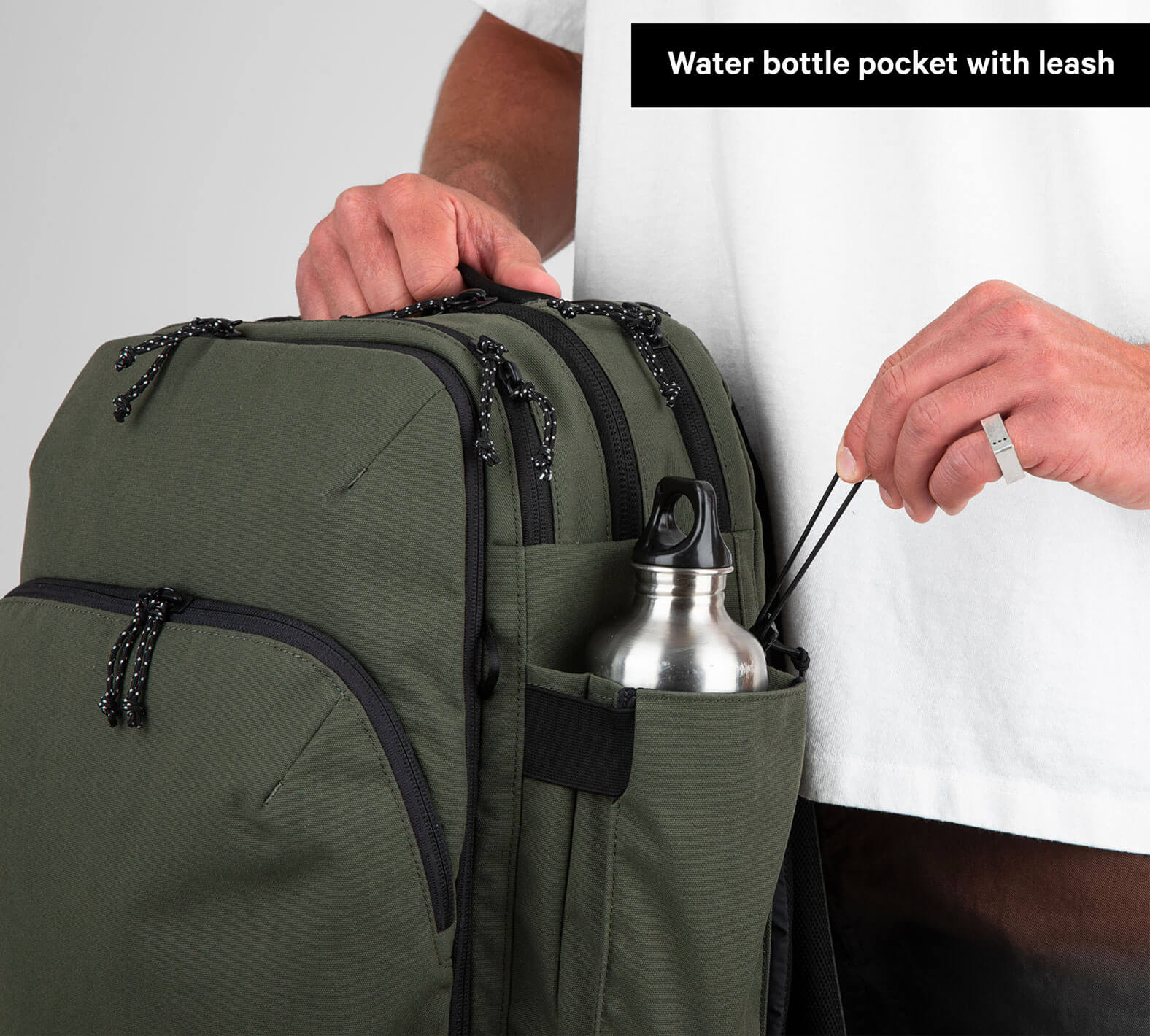 Travel Backpack Green storage space demonstrated with water bottle