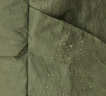 Close-up of the Aeroweave fabric in Cypress with water droplets, highlighting water-resistant material