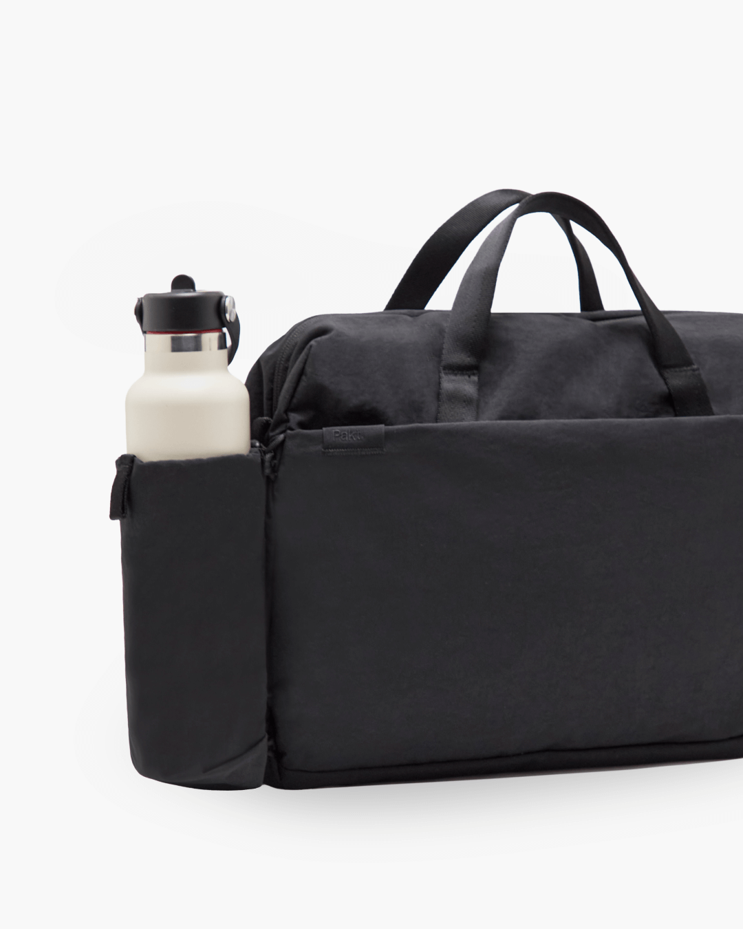 Front view of MODE Shoulder Bag 12L showcasing side bottle sleeve with cream water bottle on white background