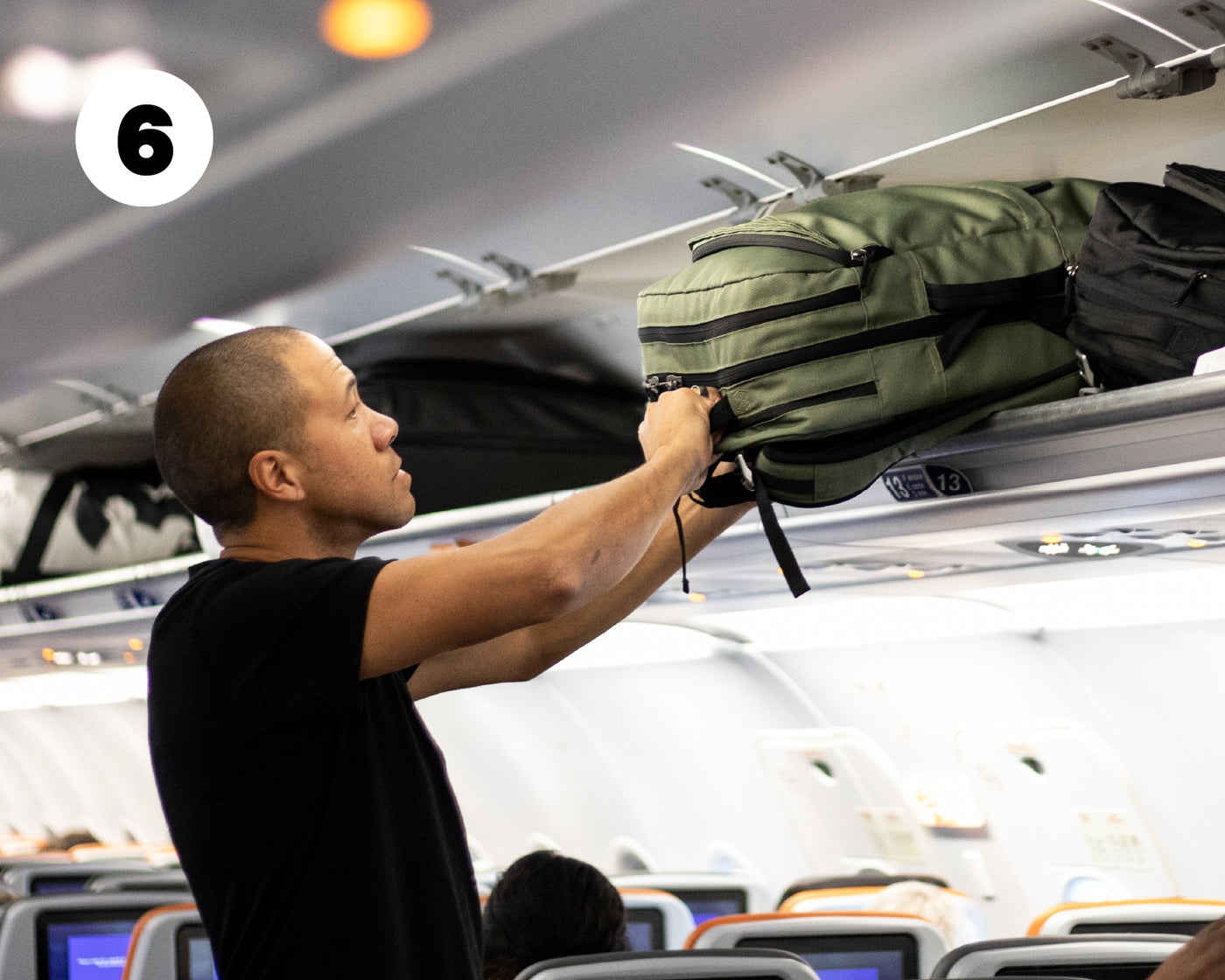 The Pakt Travel Backpack placed in the overhead compartment of an airplane