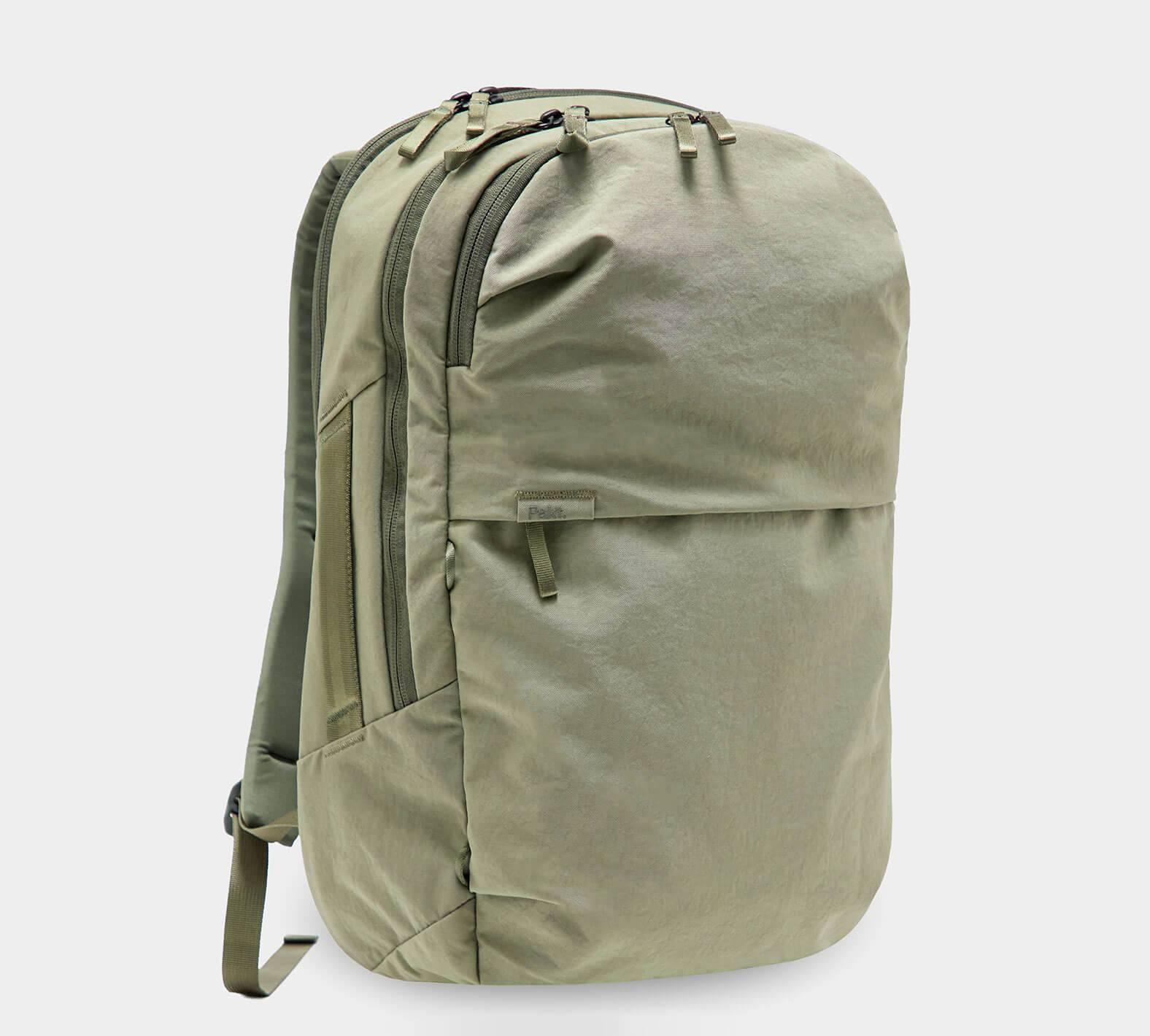 Olive-green canvas daypack backpack with two zip compartments, front zip pocket and padded shoulder straps