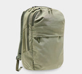Olive-green canvas daypack backpack with two zip compartments, front zip pocket and padded shoulder straps