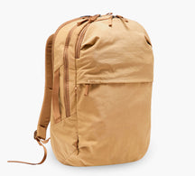 Angled front view of MODE Backpack 22L in Sumac showcasing zip compartments, front and side pockets and padded straps