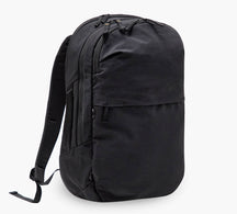 Black commuter backpack with two zip compartments, front zip pocket and padded shoulder straps.