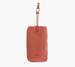 Rust-colored drawstring bottle sleeve embroidered with 'Pakt.' logo