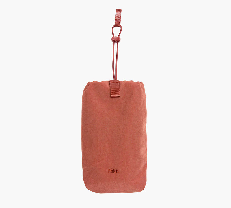 Rust-colored drawstring bottle sleeve embroidered with 'Pakt.' logo