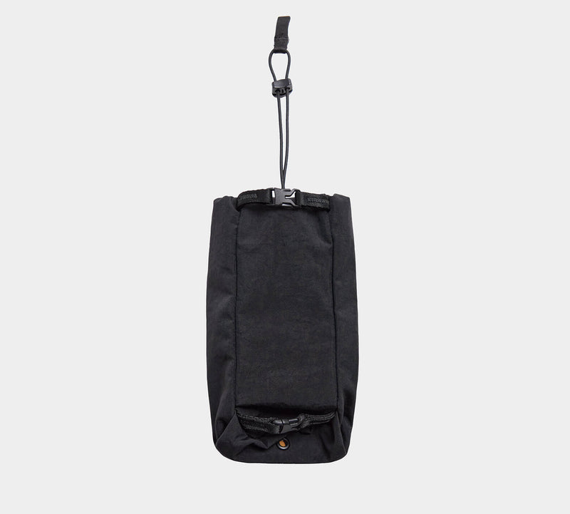 Front view of MODE Bottle Sleeve in black showing hanging strap with plastic clip and roll-top buckle on light gray background