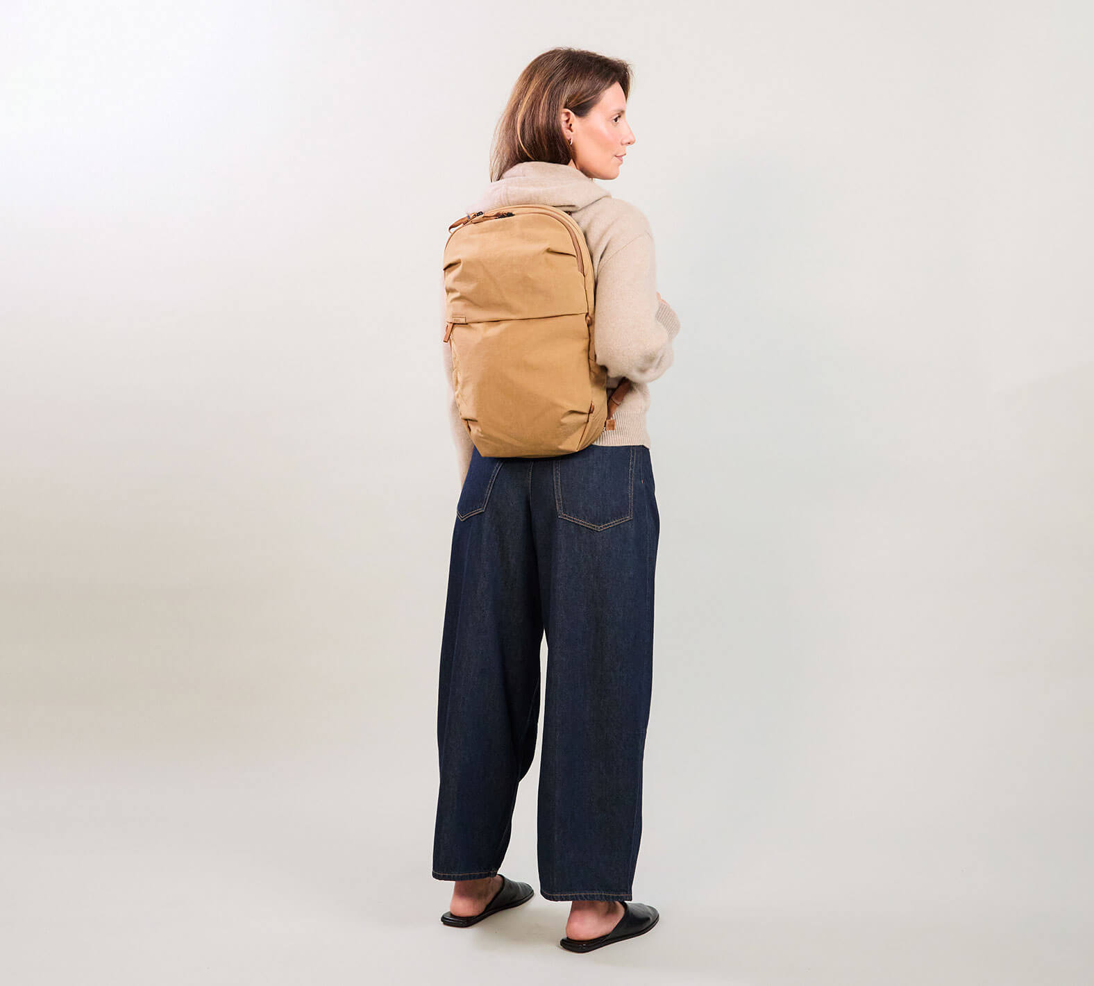 Rear view of MODE Convertible Bag 14L in Mojave showing backpack carry with padded straps on neutral background