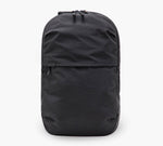 Black minimalist backpack with top dual zippers and front zip pocket