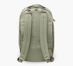 Sage green backpack, rear view — padded shoulder straps, top carry handle, and side zipper pocket.