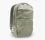 sage-green travel backpack with front zip pocket, padded back panel, and side water-bottle pocket