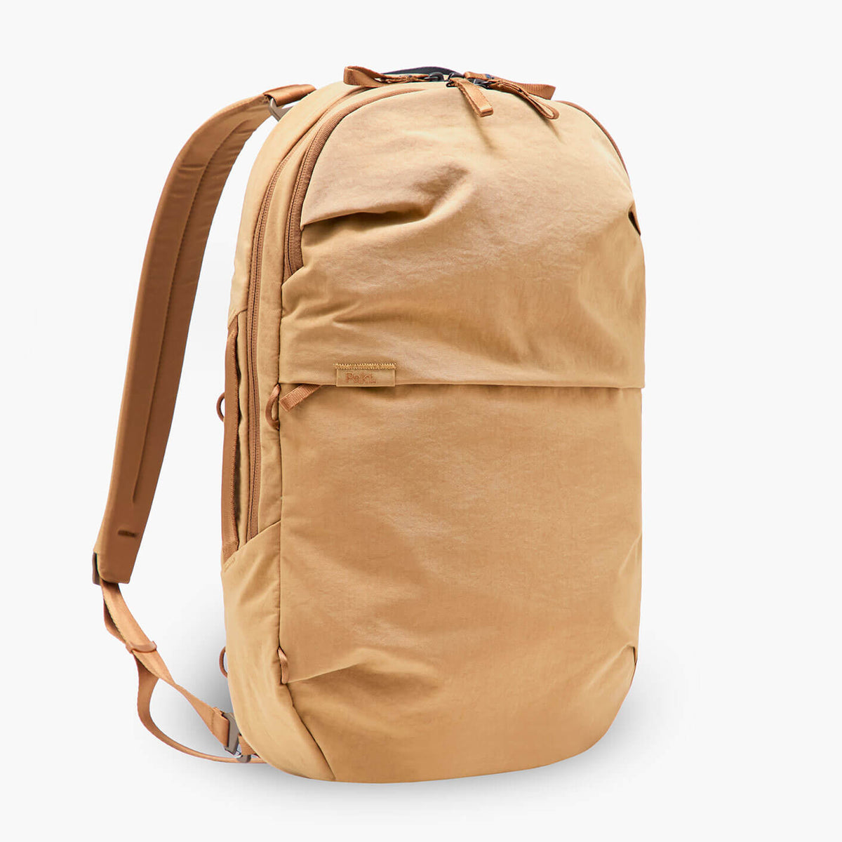 Three-quarter view of MODE Convertible Bag 14L in Mojave showing front pocket, top zipper, and straps on white background