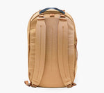 Rear view of tan backpack with padded shoulder straps and black top grab handle.