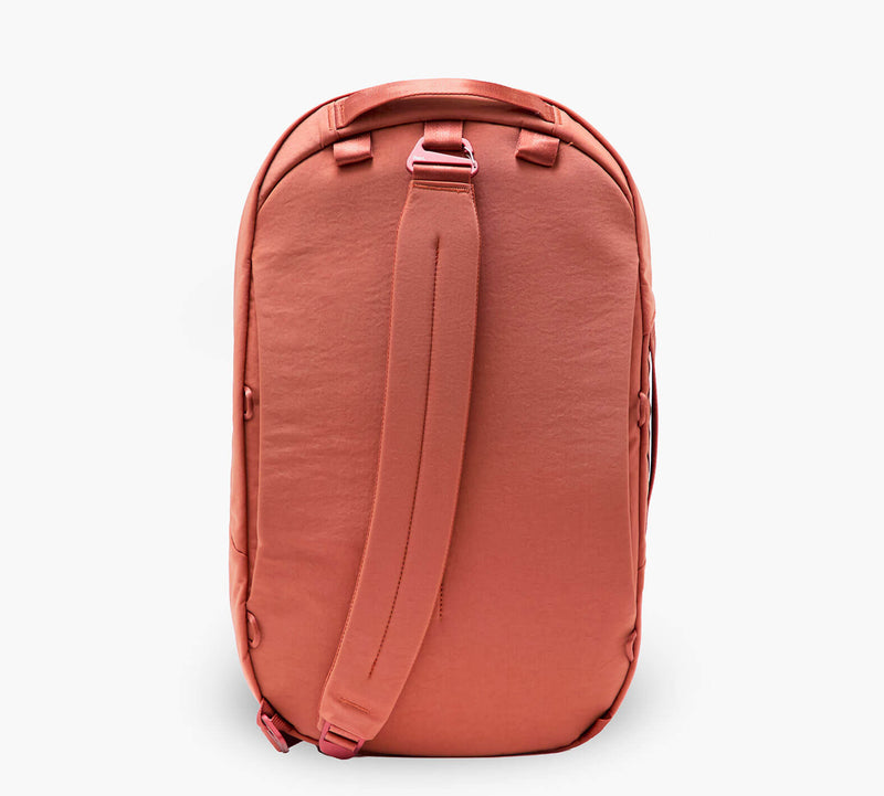 Back view of coral backpack showing rear panel and shoulder straps.