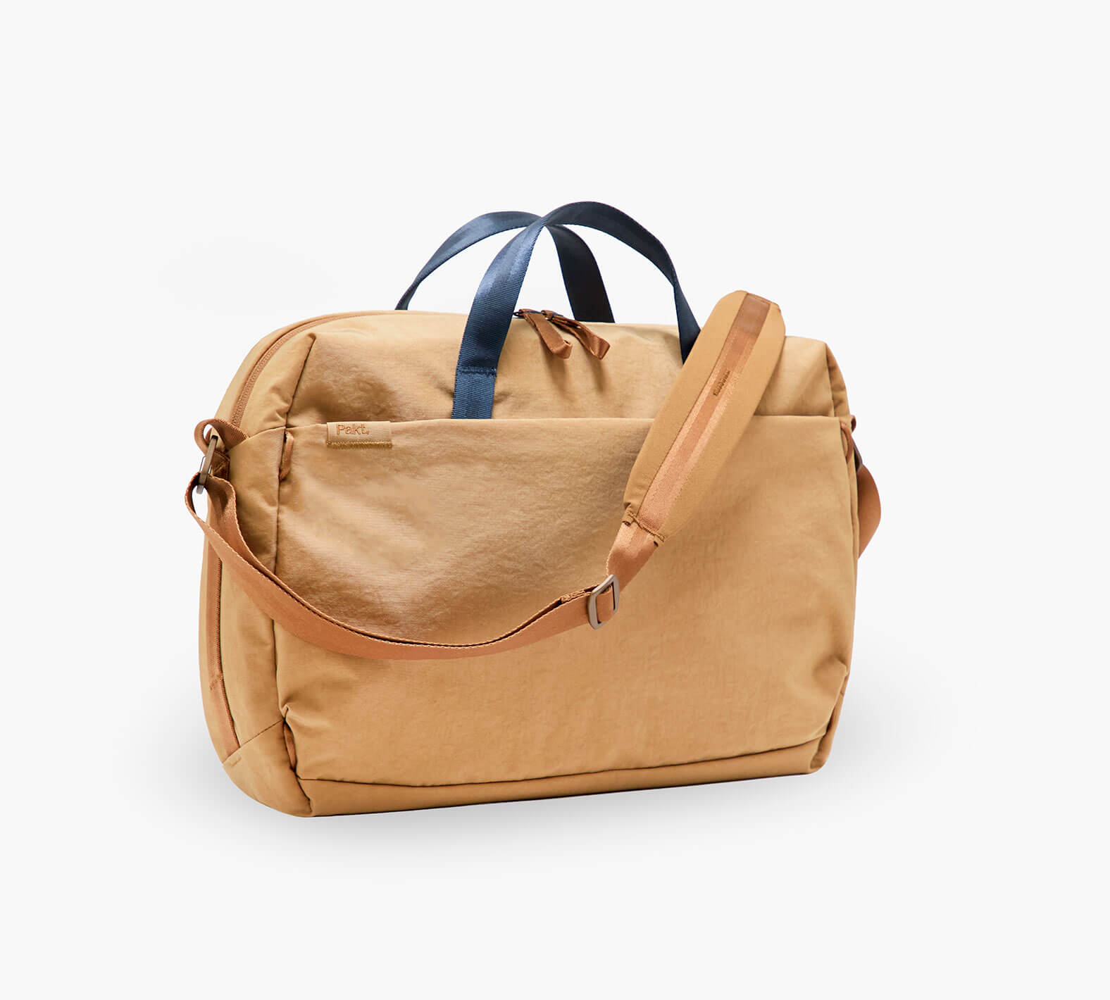 Front three-quarter view of MODE Shoulder Bag 12L showing Mojave canvas body, navy top handles, and adjustable shoulder strap on white background