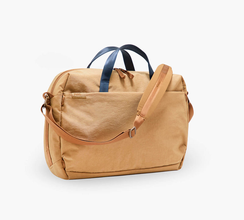 tan canvas weekender bag with navy top handles and adjustable tan shoulder strap
