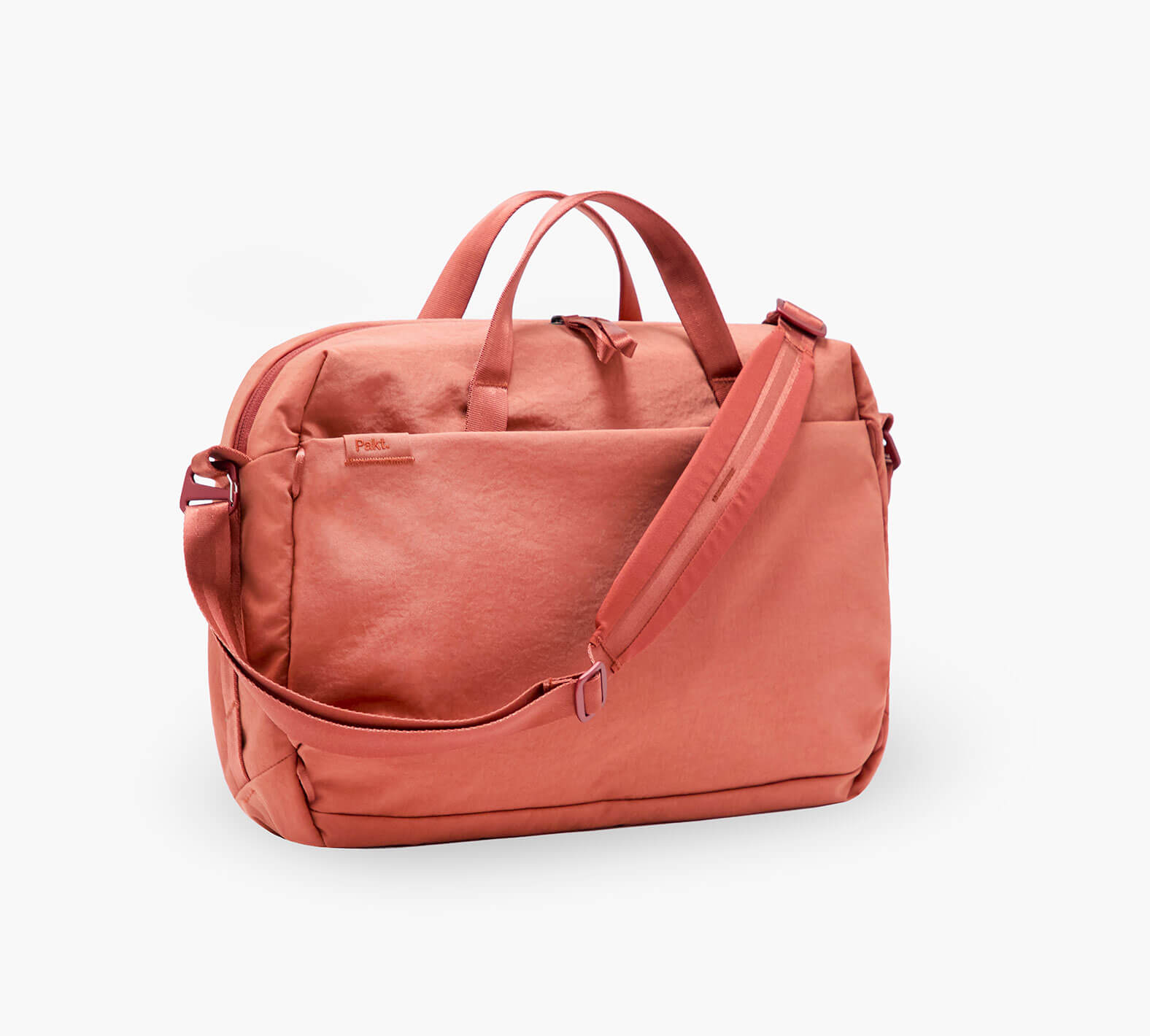 Three-quarter view of MODE Shoulder Bag 12L in Sumac with front pocket and adjustable shoulder strap on white background