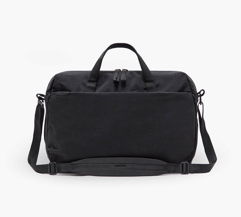 Black rectangular travel weekender bag with top handles, adjustable shoulder strap and front zip pocket.