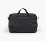 Black travel weekender bag with top handles and front zip pocket.
