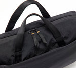 Black padded laptop bag with two top handles and double zipper pulls