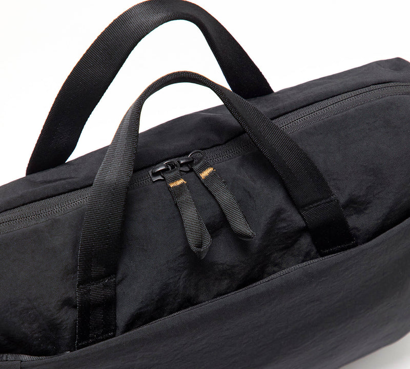 Black padded laptop bag with two top handles and double zipper pulls