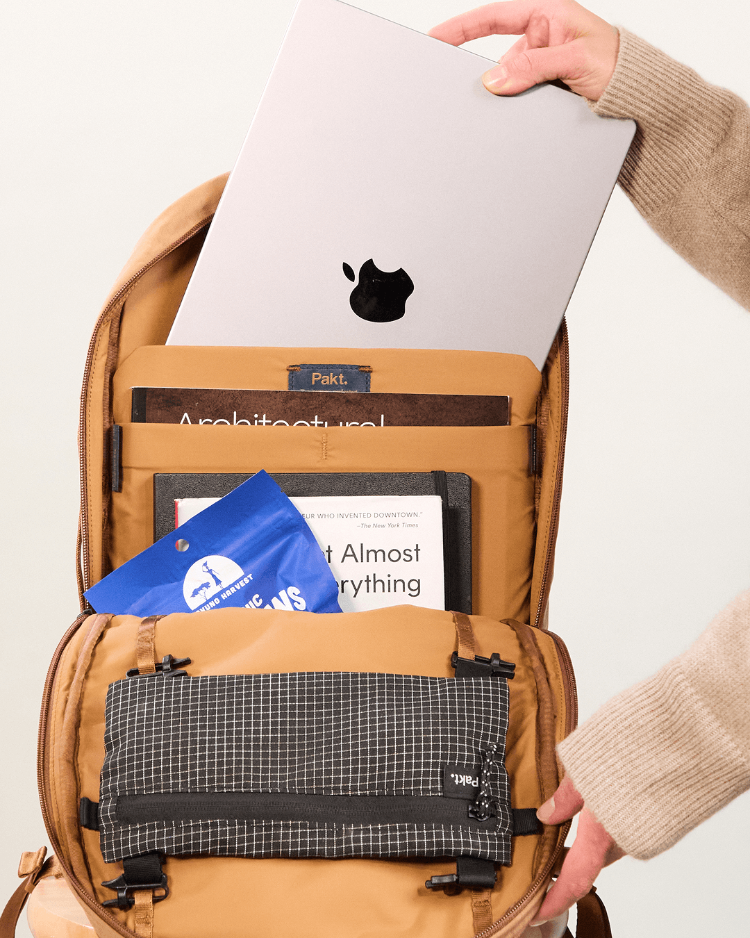 Front-open view of MODE Convertible Bag 14L in Mojave showing padded 16-inch laptop sleeve, organizer pockets and grid pouch