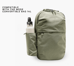 Backpack side bottle sleeve holding a white bottle; words: COMPATIBLE WITH THE MODE CONVERTIBLE BAG 14L