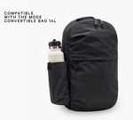 COMPATIBLE WITH THE MODE CONVERTIBLE BAG 14L — black backpack showing side bottle sleeve holding white bottle