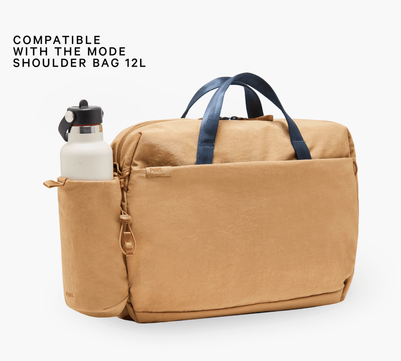 Tan bottle sleeve on Mode 12L shoulder bag with white bottle — COMPATIBLE WITH THE MODE SHOULDER BAG 12L; Pakt.