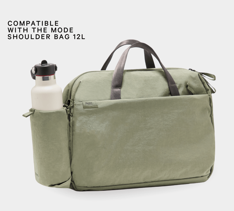 Olive bottle sleeve on Mode bag holding white bottle; header reads COMPATIBLE WITH THE MODE SHOULDER BAG 12L; Pakt