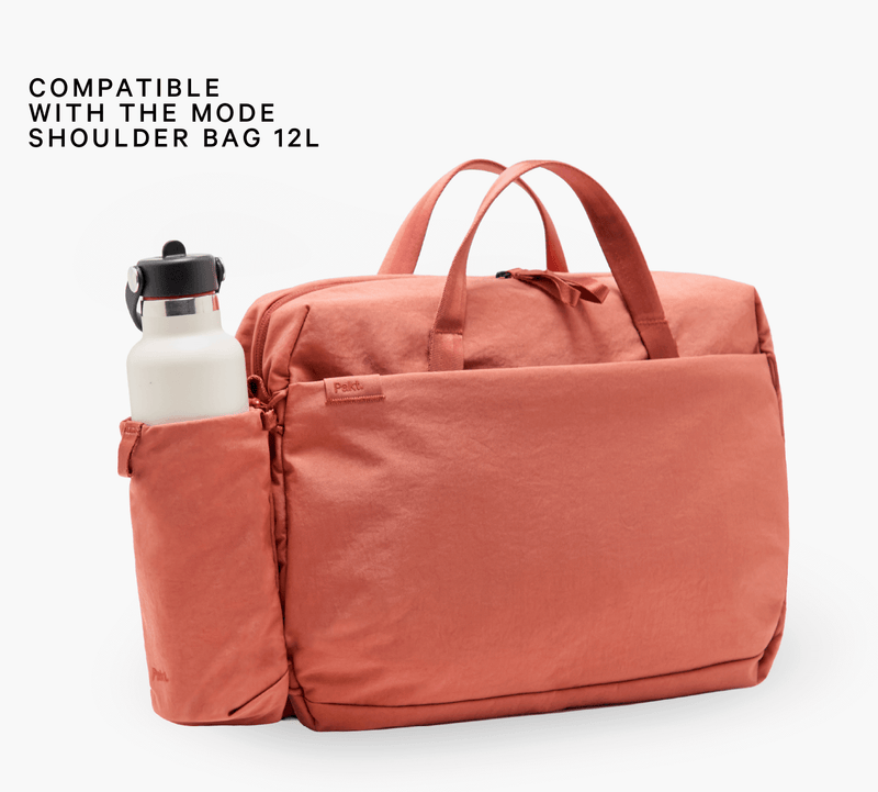 COMPATIBLE WITH THE MODE SHOULDER BAG 12L — coral Mode shoulder bag with insulated side bottle sleeve holding white bottle