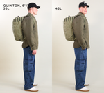 QUINTON, 6'1" wearing olive jacket and blue jeans in profile with 35L pack (left) and 45L (right)